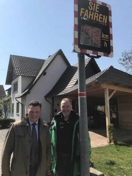 Bürgermeister Wilhelm Gebhard und Rüdiger Kunz, ehrenamtlicher Mitarbeiter der Verkehrswacht und Verkehrspolizist, vor der neu installierten Signaltafel.